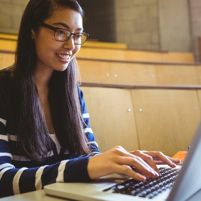 find-internship-careerdc-guide A female university student is using her laptop to search for an internship using CareerDC's strategic internship search guide.