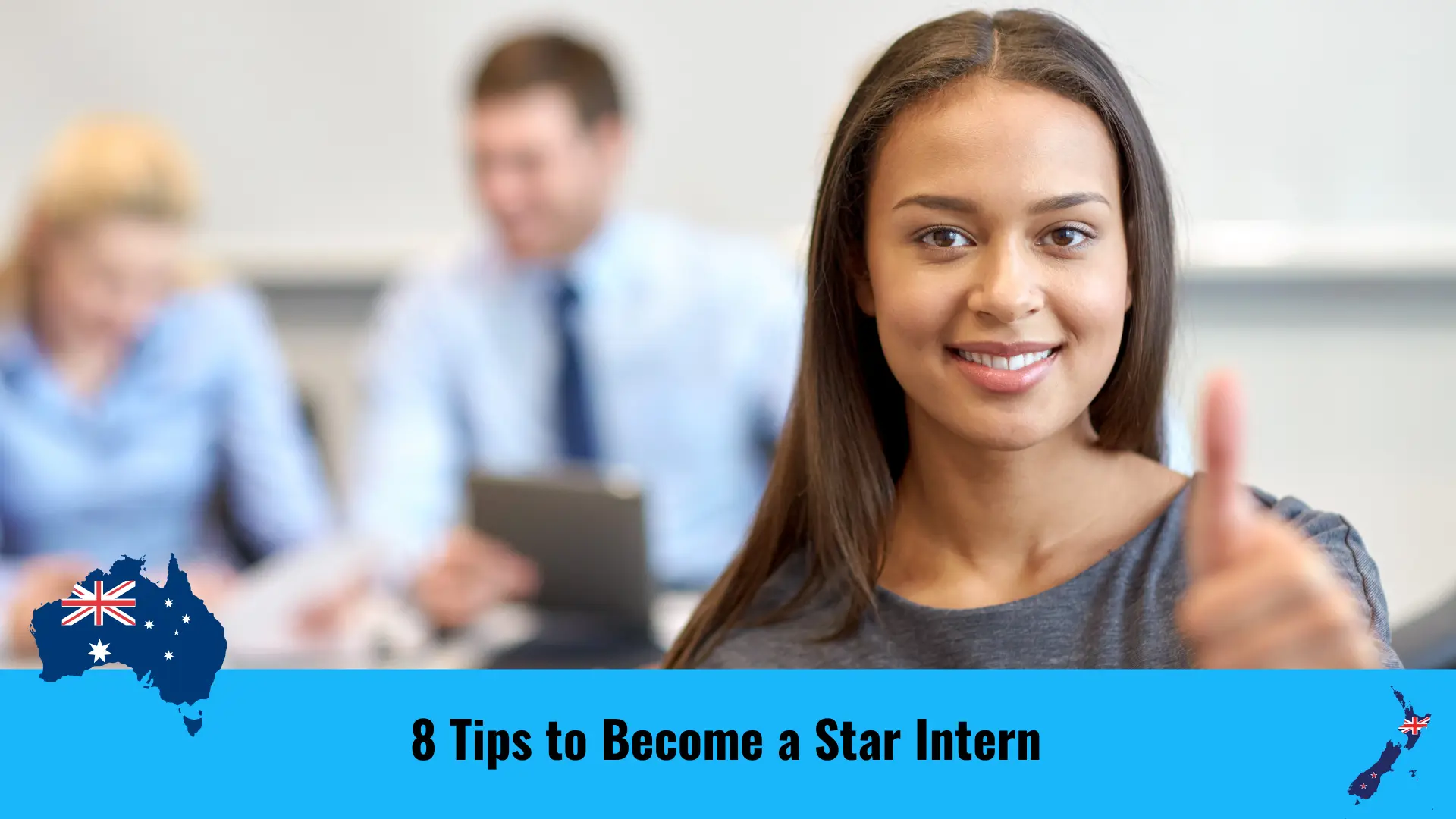 A confident-looking female intern is looking at the camera with a smile and a thumb up with team members to be seen in the background in a professional working environment.